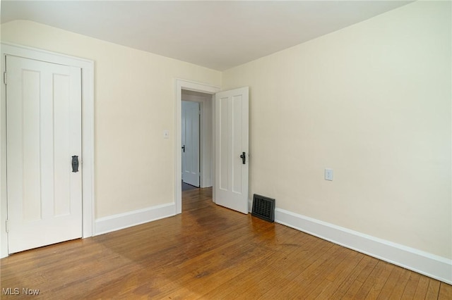 unfurnished bedroom with hardwood / wood-style floors