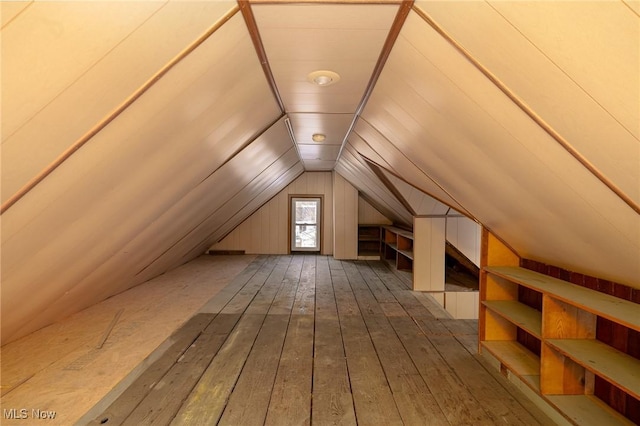 bonus room featuring lofted ceiling and dark hardwood / wood-style flooring