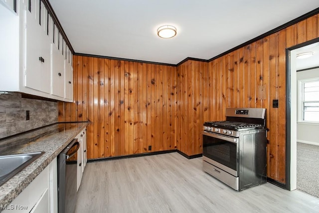 kitchen with crown molding, dishwasher, white cabinets, light wood-type flooring, and stainless steel range with gas cooktop