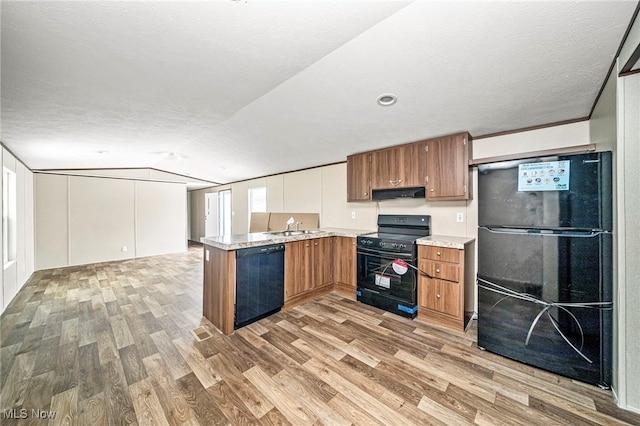 kitchen with lofted ceiling, sink, hardwood / wood-style floors, black appliances, and a textured ceiling