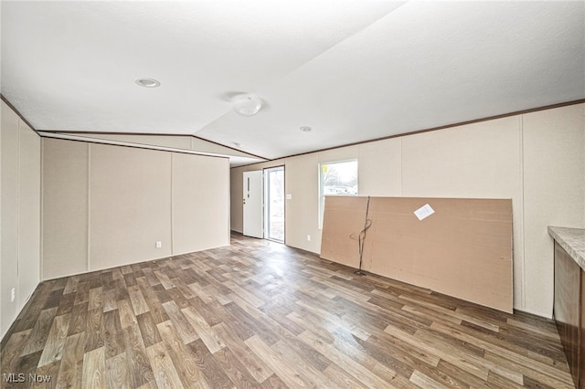 basement with hardwood / wood-style flooring and ornamental molding