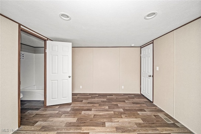 basement featuring hardwood / wood-style flooring and a textured ceiling