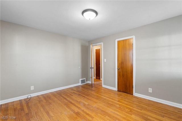 spare room with light hardwood / wood-style flooring