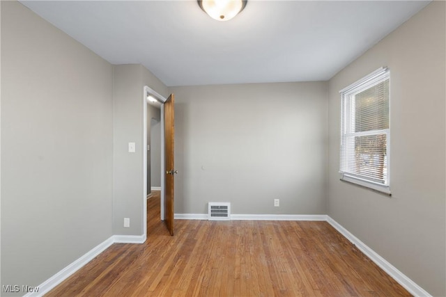 unfurnished room featuring wood-type flooring