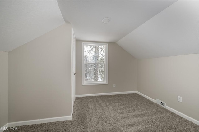 bonus room featuring vaulted ceiling and carpet floors