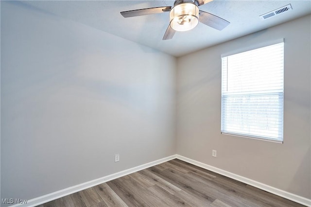 unfurnished room with hardwood / wood-style flooring and ceiling fan