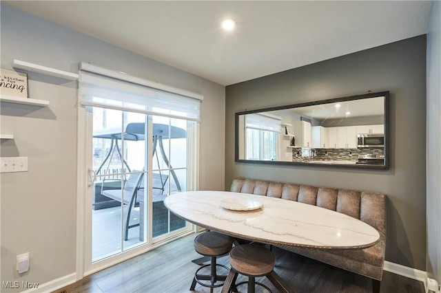 dining room featuring wood-type flooring and breakfast area