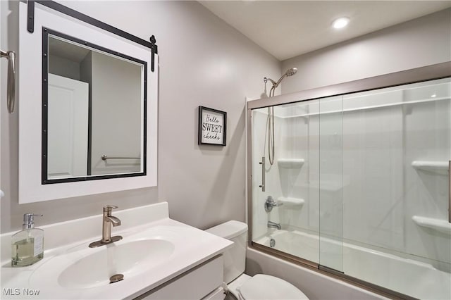 full bathroom featuring shower / bath combination with glass door, vanity, and toilet