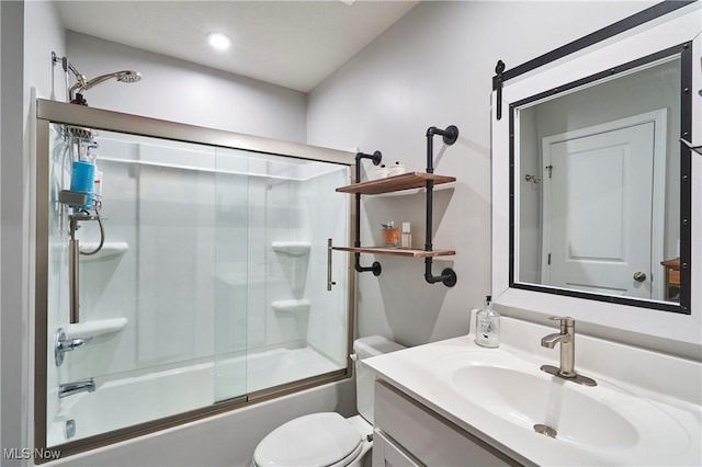 full bathroom featuring enclosed tub / shower combo, vanity, and toilet