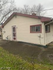 view of side of home with a yard