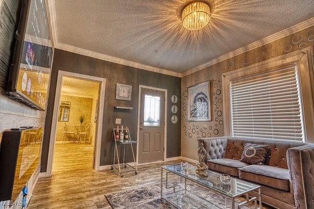 living room featuring wood-type flooring, a textured ceiling, and crown molding