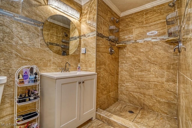 bathroom featuring vanity, crown molding, a tile shower, and tile walls