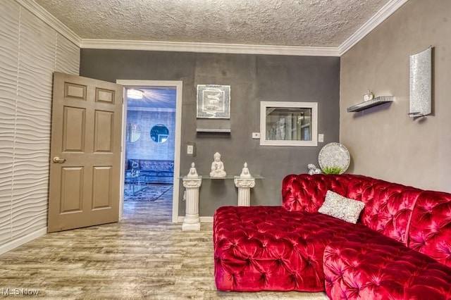 living room with ornamental molding, hardwood / wood-style floors, and a textured ceiling