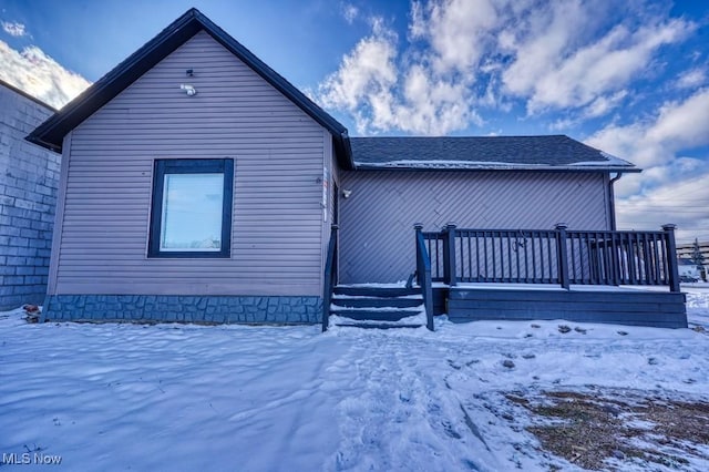 view of snow covered rear of property