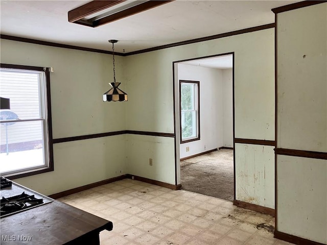 unfurnished dining area featuring ornamental molding