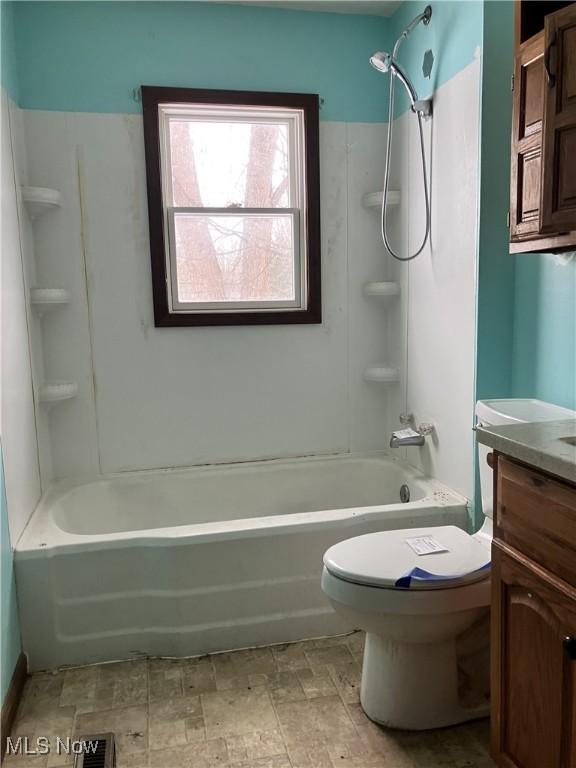 full bathroom featuring bathing tub / shower combination, toilet, and vanity