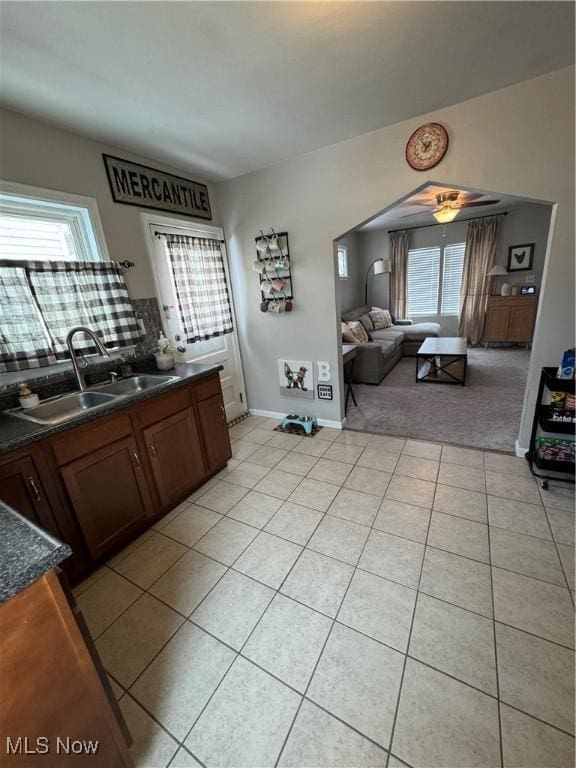 kitchen with sink, light tile patterned flooring, and a wealth of natural light