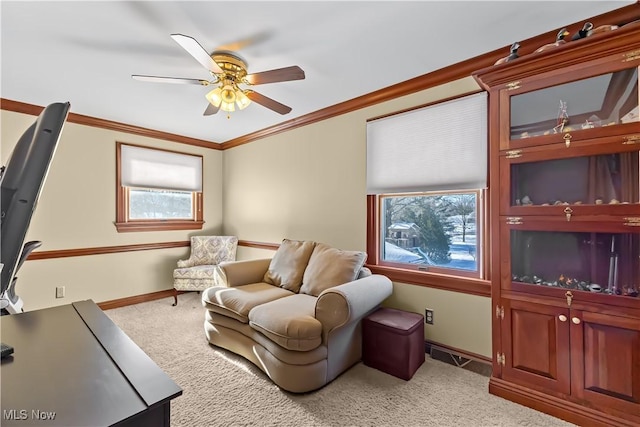 interior space with ceiling fan, ornamental molding, and light carpet