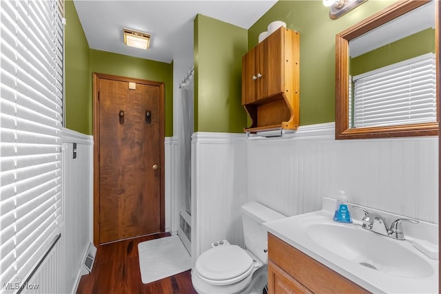 bathroom featuring vanity, toilet, hardwood / wood-style floors, and a shower with shower curtain