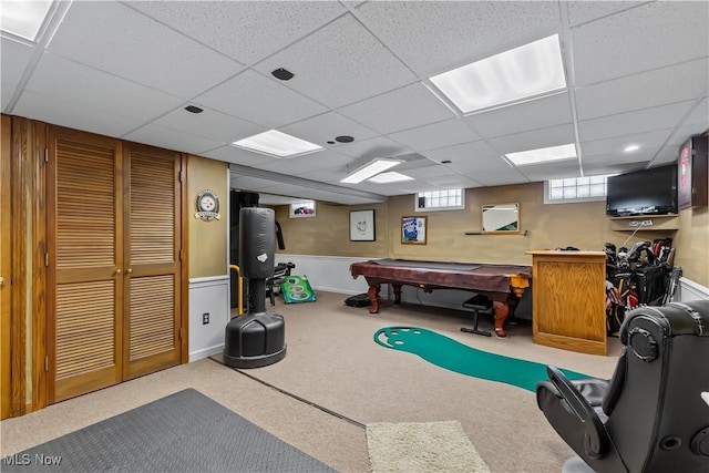 game room with a paneled ceiling and carpet flooring