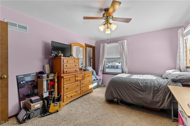 bedroom featuring ceiling fan and light carpet