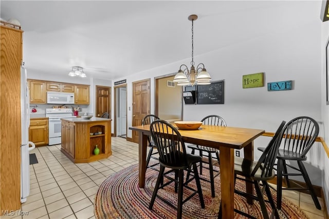 dining space featuring light tile patterned floors and a chandelier