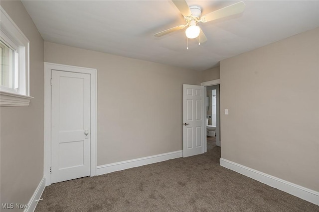 unfurnished bedroom featuring a ceiling fan, baseboards, and carpet floors