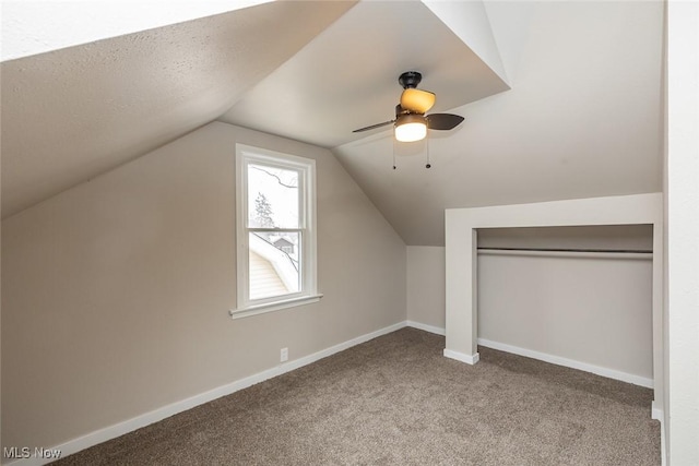 additional living space with ceiling fan, baseboards, lofted ceiling, and carpet