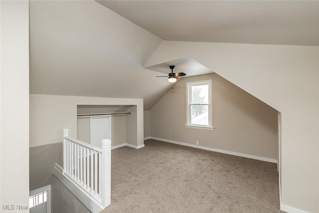 bonus room with vaulted ceiling, carpet, baseboards, and ceiling fan