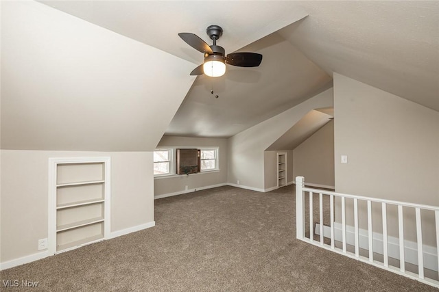 additional living space with carpet flooring, lofted ceiling, built in features, and baseboards