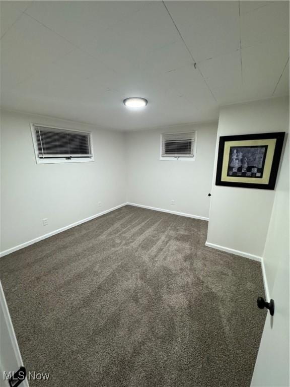 basement featuring dark colored carpet