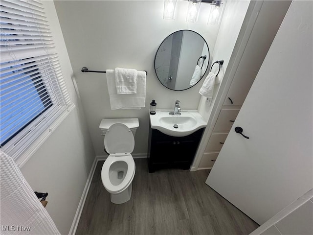 bathroom featuring vanity, hardwood / wood-style flooring, and toilet