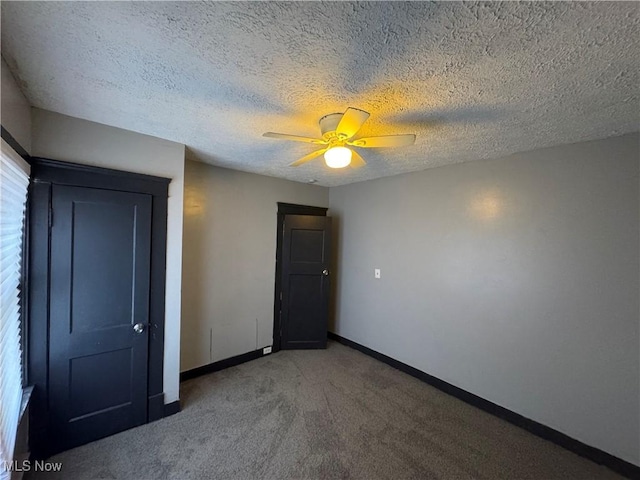 unfurnished bedroom with carpet floors, a textured ceiling, and ceiling fan