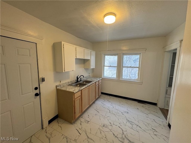 kitchen featuring sink and a textured ceiling