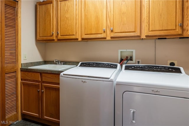 laundry area with cabinets, sink, and washing machine and dryer