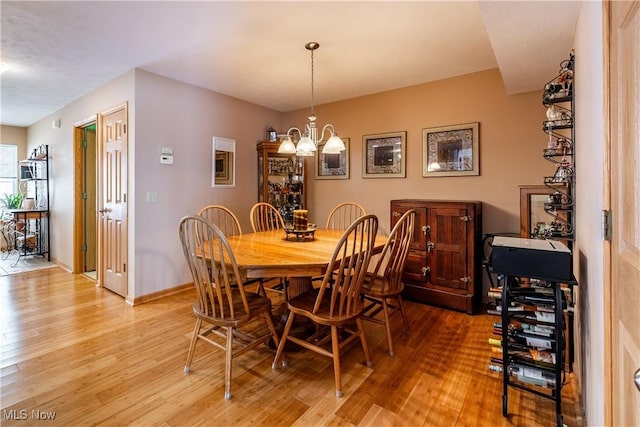 dining room featuring a chandelier and light wood-type flooring