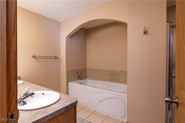 bathroom featuring vanity, a bathing tub, and tile patterned floors