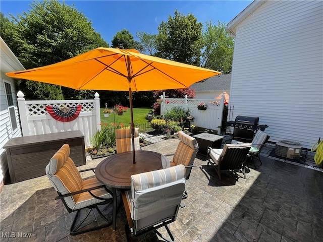 view of patio / terrace featuring cooling unit, area for grilling, outdoor dining space, and fence