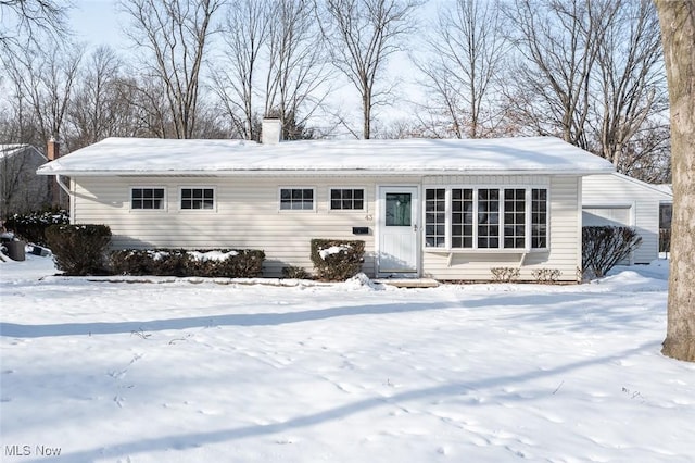 view of snow covered back of property