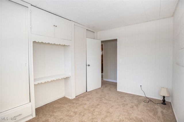 unfurnished bedroom with light colored carpet