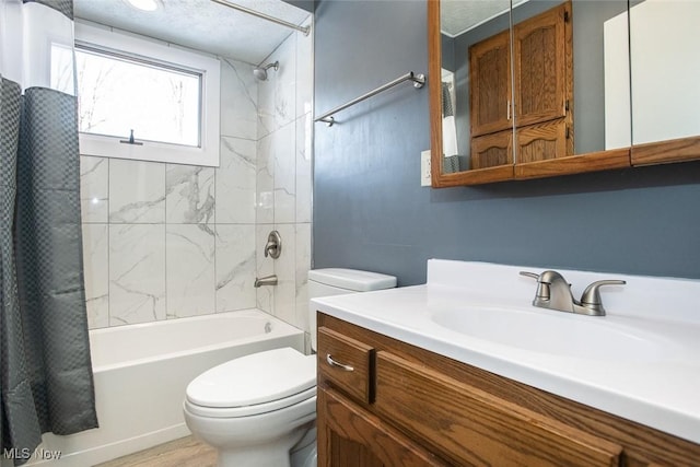 full bathroom featuring toilet, shower / bathtub combination with curtain, and vanity