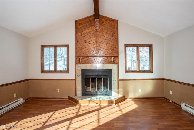 unfurnished living room featuring wood-type flooring, a tile fireplace, and baseboard heating