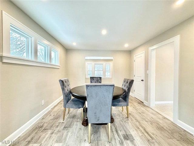 dining room with a wealth of natural light and hardwood / wood-style floors