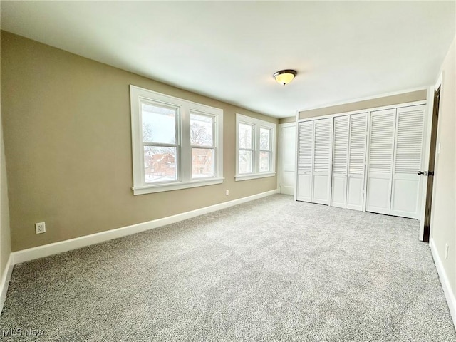 unfurnished bedroom featuring a closet and carpet flooring