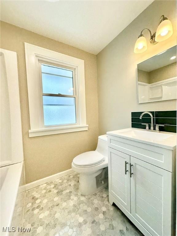 bathroom featuring toilet and vanity