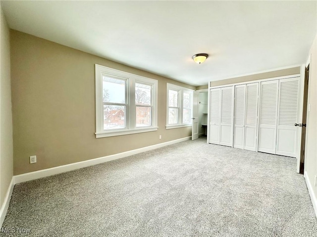 unfurnished bedroom featuring a closet and carpet flooring