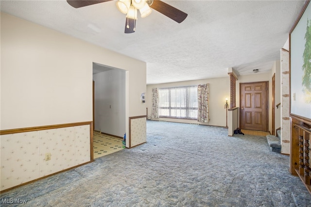 interior space with carpet floors and a textured ceiling