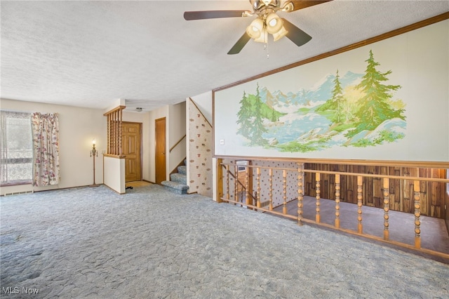 carpeted spare room with a textured ceiling and ornamental molding