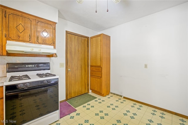 kitchen featuring white range with gas stovetop