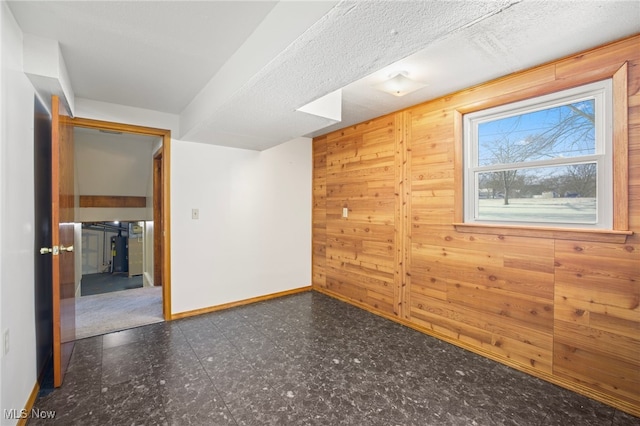 unfurnished room with wood walls